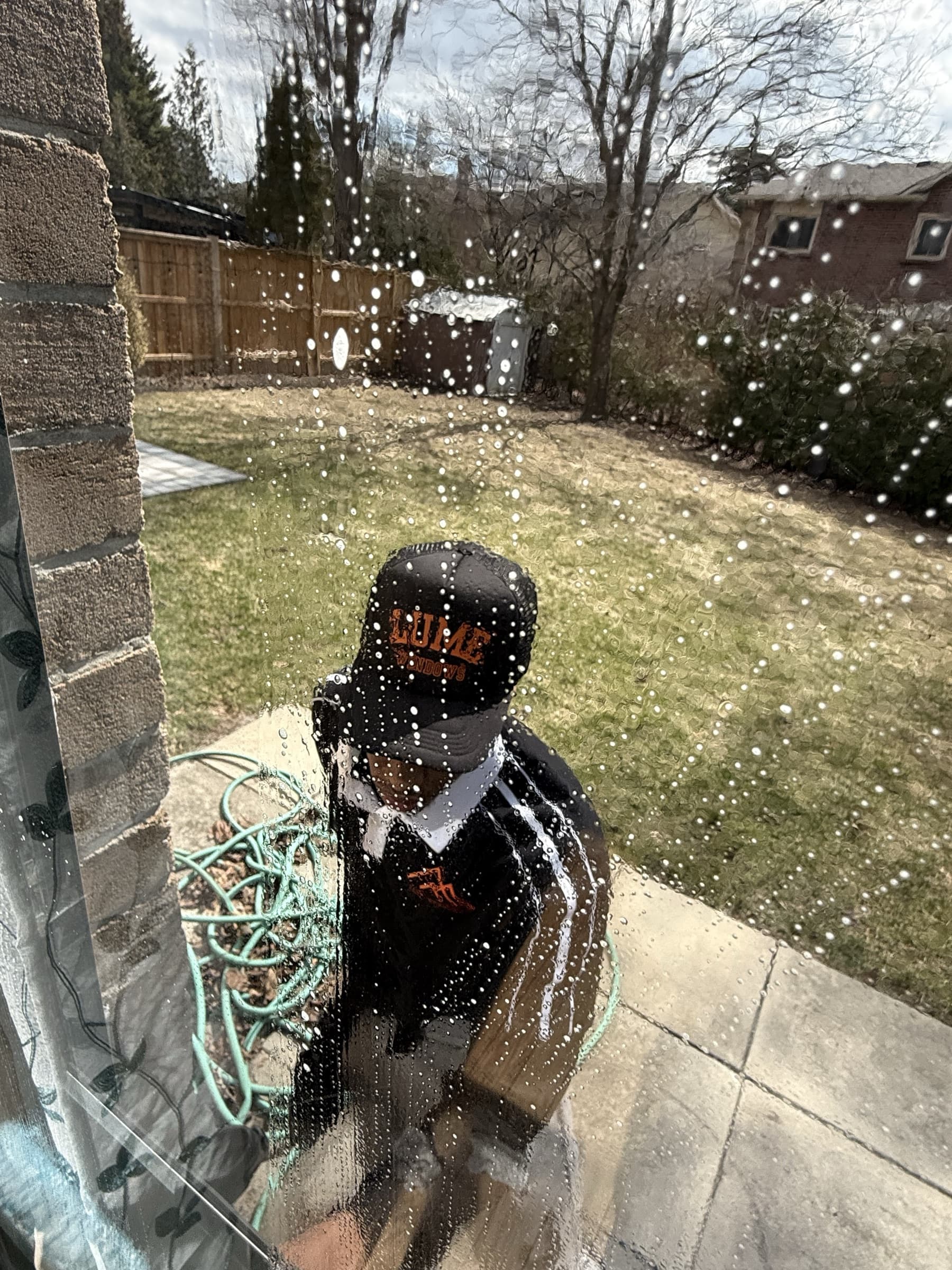 Lume Windows technician scrubbing a window pane up close